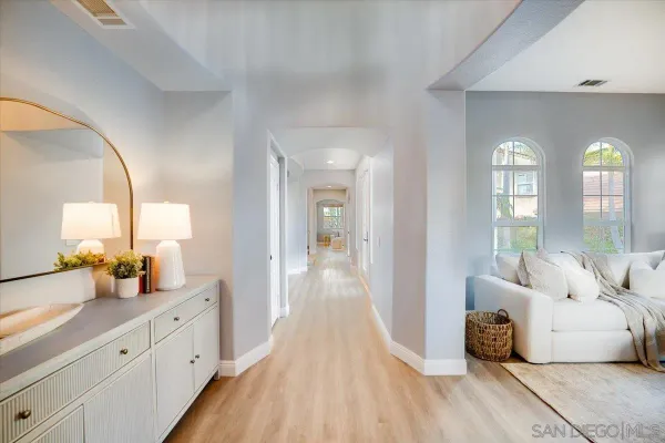 a spacious bedroom with a bed and a large window