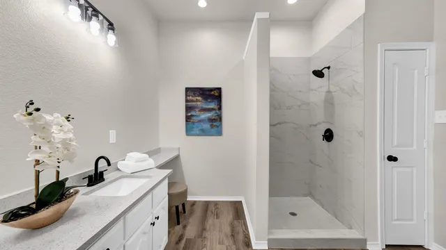 a bathroom with a tub sink and mirror