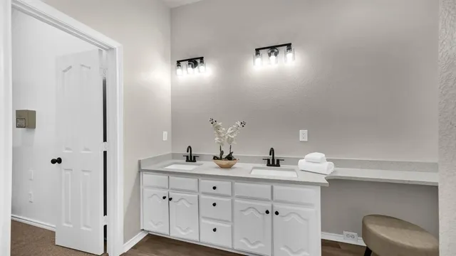 a bathroom with a double vanity sink and a mirror