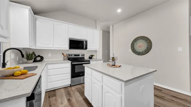 a kitchen with sink cabinets and a stove