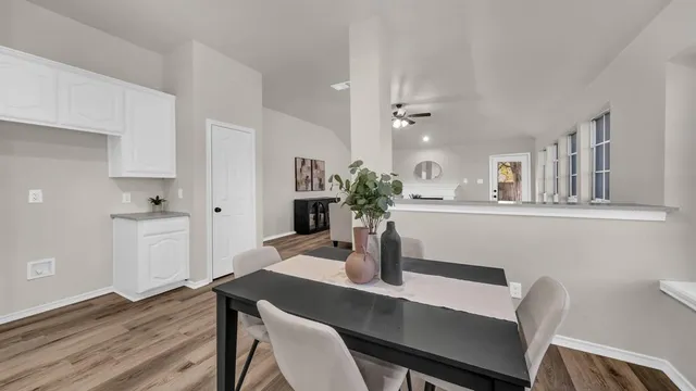 a view of a dining room with furniture and wooden floor