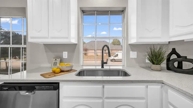 a kitchen with a sink a counter and cabinets
