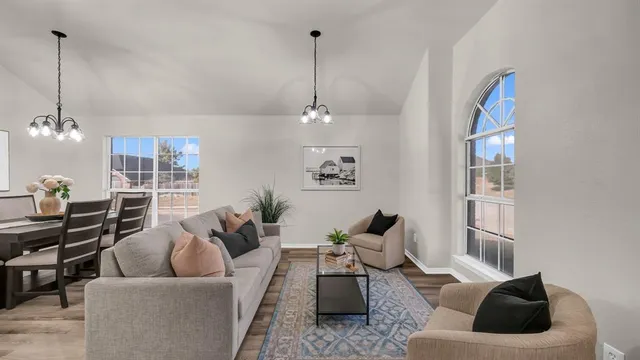 a living room with furniture and wooden floor