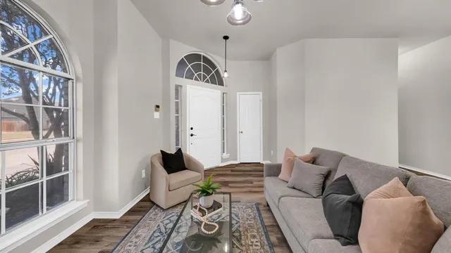 a bedroom with furniture and wooden floor