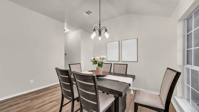 a dining room with furniture and wooden floor