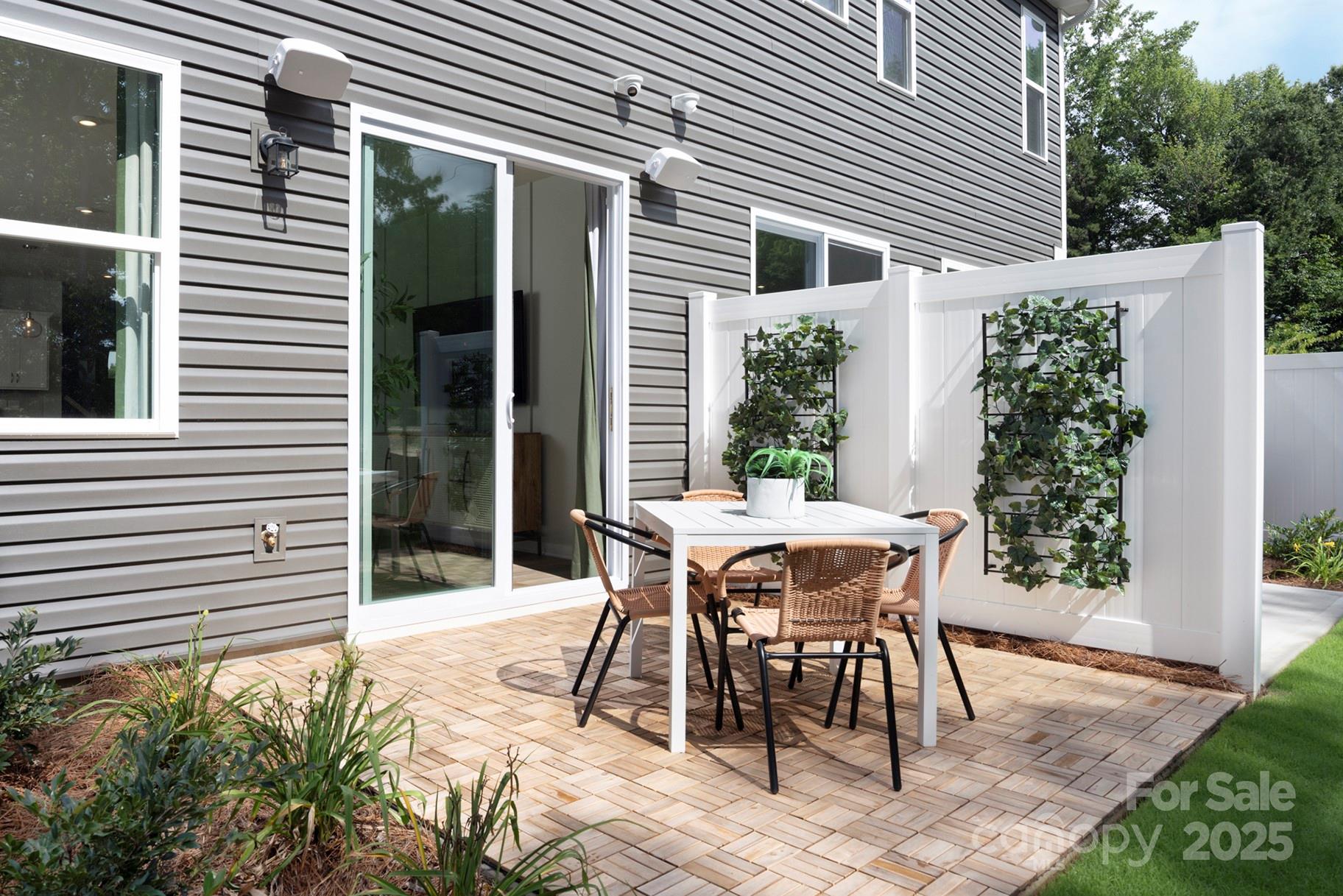1118 Vibrant Road Charlotte, NC 28215 - Photo 12 of 14 a patio with table and chairs and potted plants