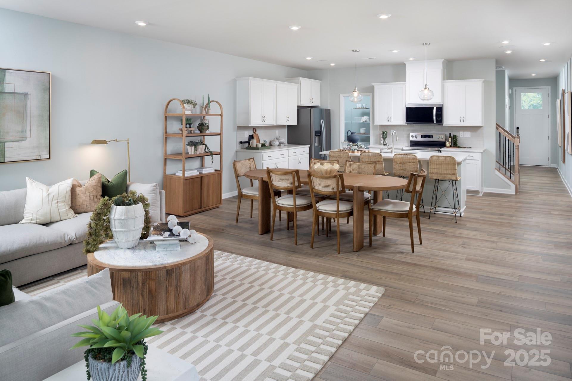 1118 Vibrant Road Charlotte, NC 28215 - Photo 2 of 14 a living room with furniture and a dining table with wooden floor