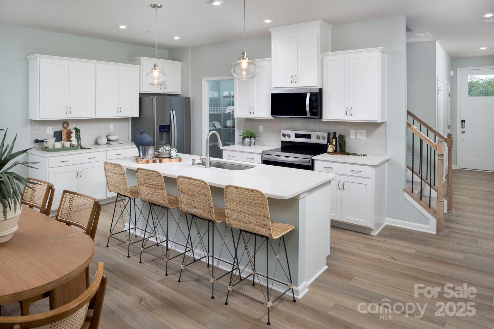 1118 Vibrant Road Charlotte, NC 28215 - Photo 4 of 14 a kitchen with stainless steel appliances kitchen island granite countertop a stove a sink a microwave and a refrigerator