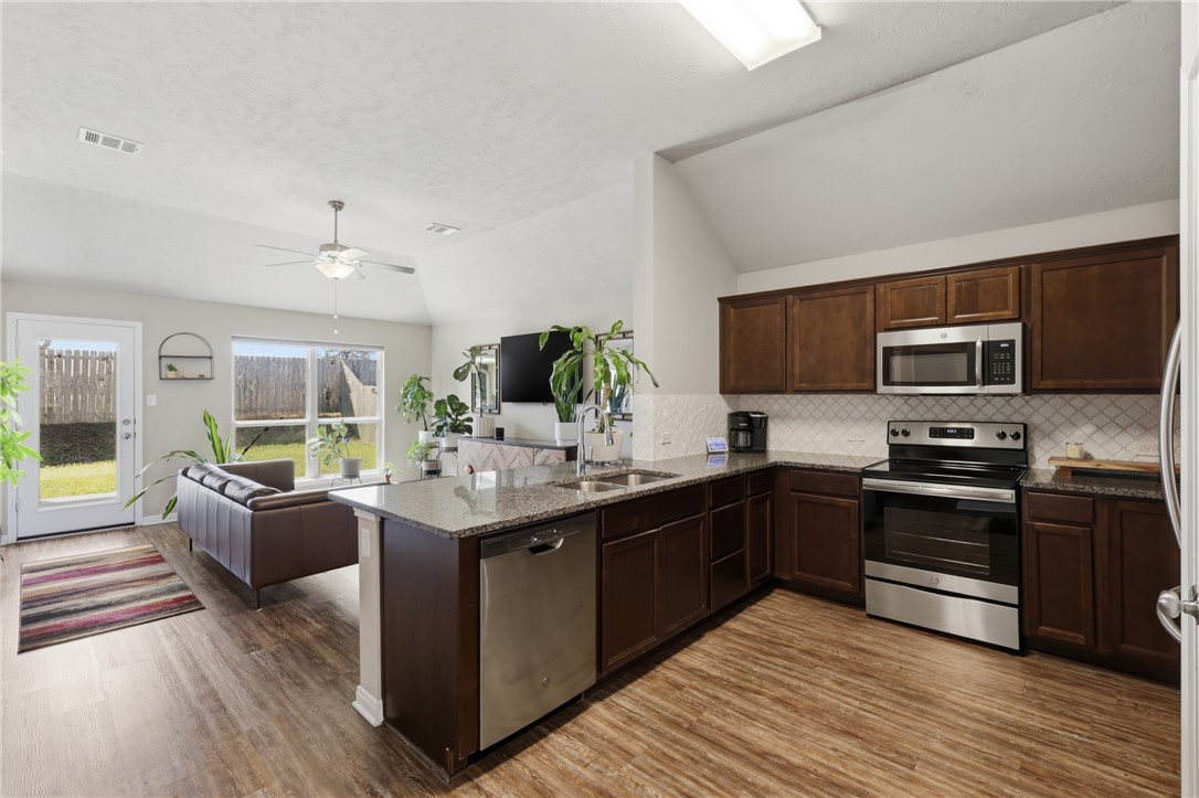 2725 Porter's Way Bryan, TX 77803 - Photo 7 of 19 a view of kitchen with stainless steel appliances granite countertop stove top oven and cabinets