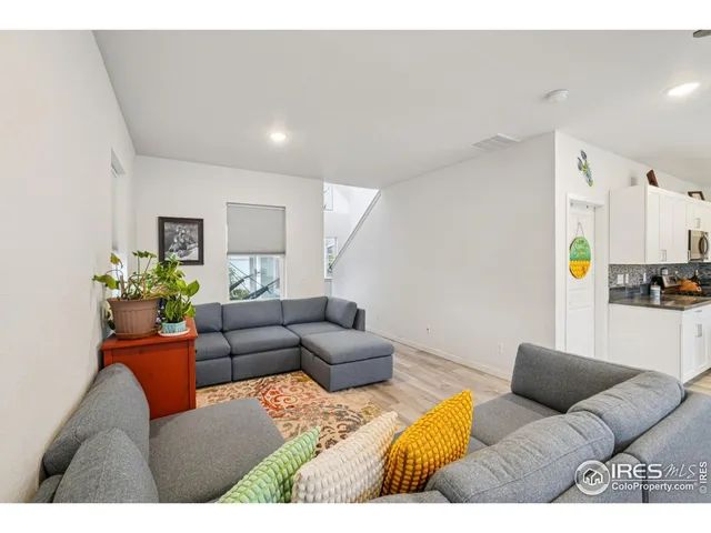a living room with furniture and painting on the wall
