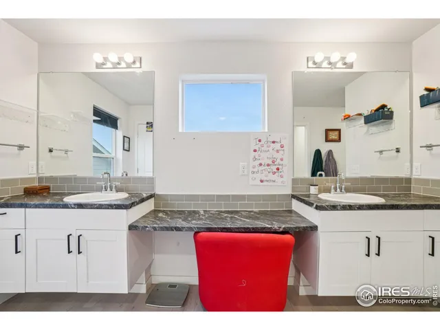 a kitchen with granite countertop a sink and cabinets