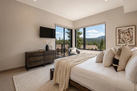 a bedroom with a bed and a flat screen tv