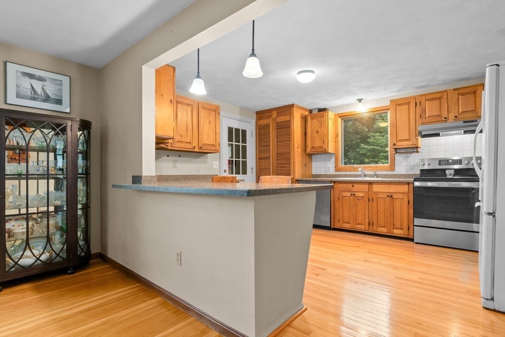 11 Heard Drive Ipswich, MA 01938 - Photo 11 of 41 a kitchen with stainless steel appliances granite countertop a stove a sink and a refrigerator