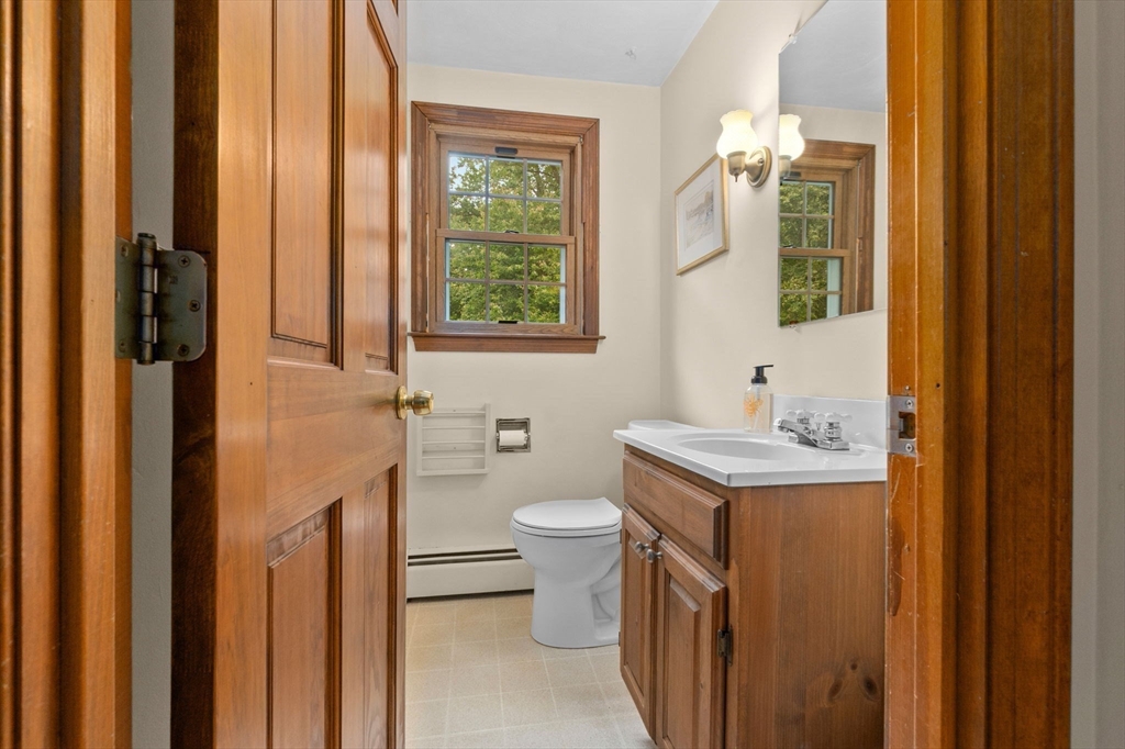 11 Heard Drive Ipswich, MA 01938 - Photo 27 of 41 a bathroom with a toilet sink and mirror