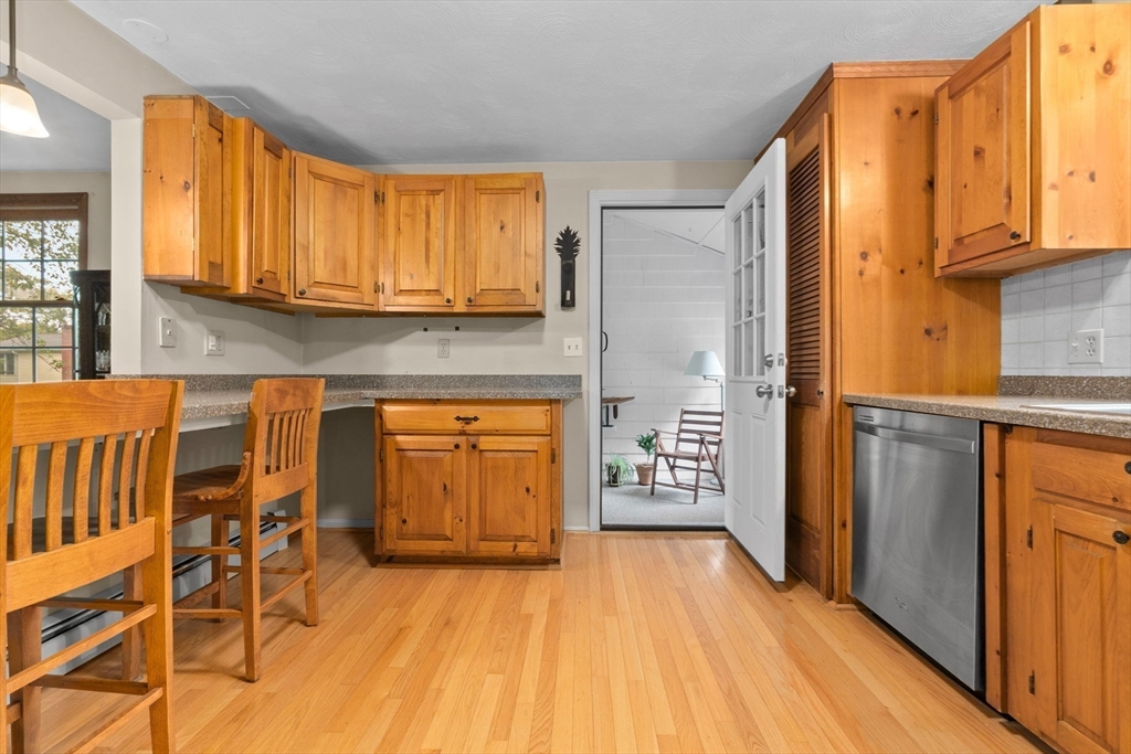 11 Heard Drive Ipswich, MA 01938 - Photo 7 of 41 a kitchen with stainless steel appliances granite countertop a refrigerator and wooden cabinets