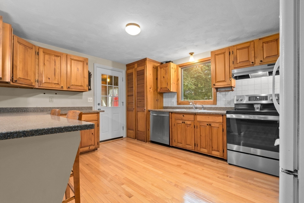 11 Heard Drive Ipswich, MA 01938 - Photo 10 of 41 a kitchen with stainless steel appliances granite countertop a stove a sink and a refrigerator