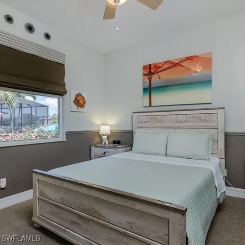 a bedroom with a bed and a painting on the wall