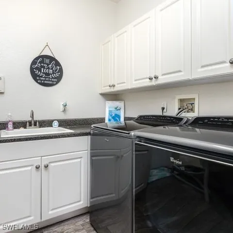 a kitchen with a sink cabinets and stainless steel appliances