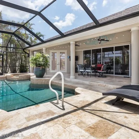 a swimming pool with outdoor seating
