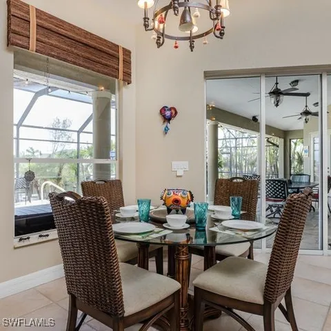 a dining room with furniture a chandelier and window