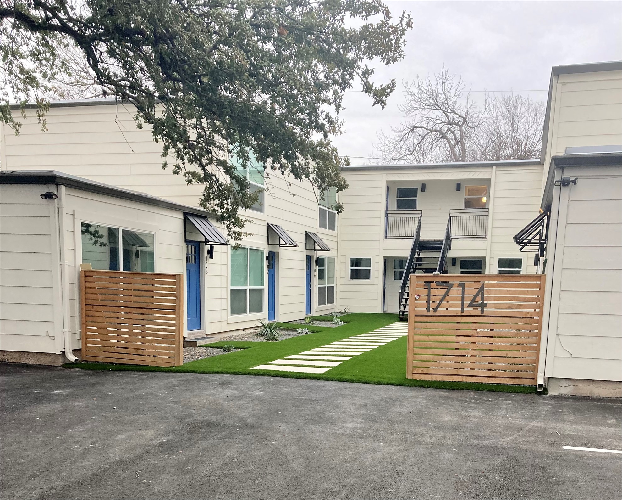 Clean lines and vibrant blue doors define the inviting entrances of these contemporary townhomes.