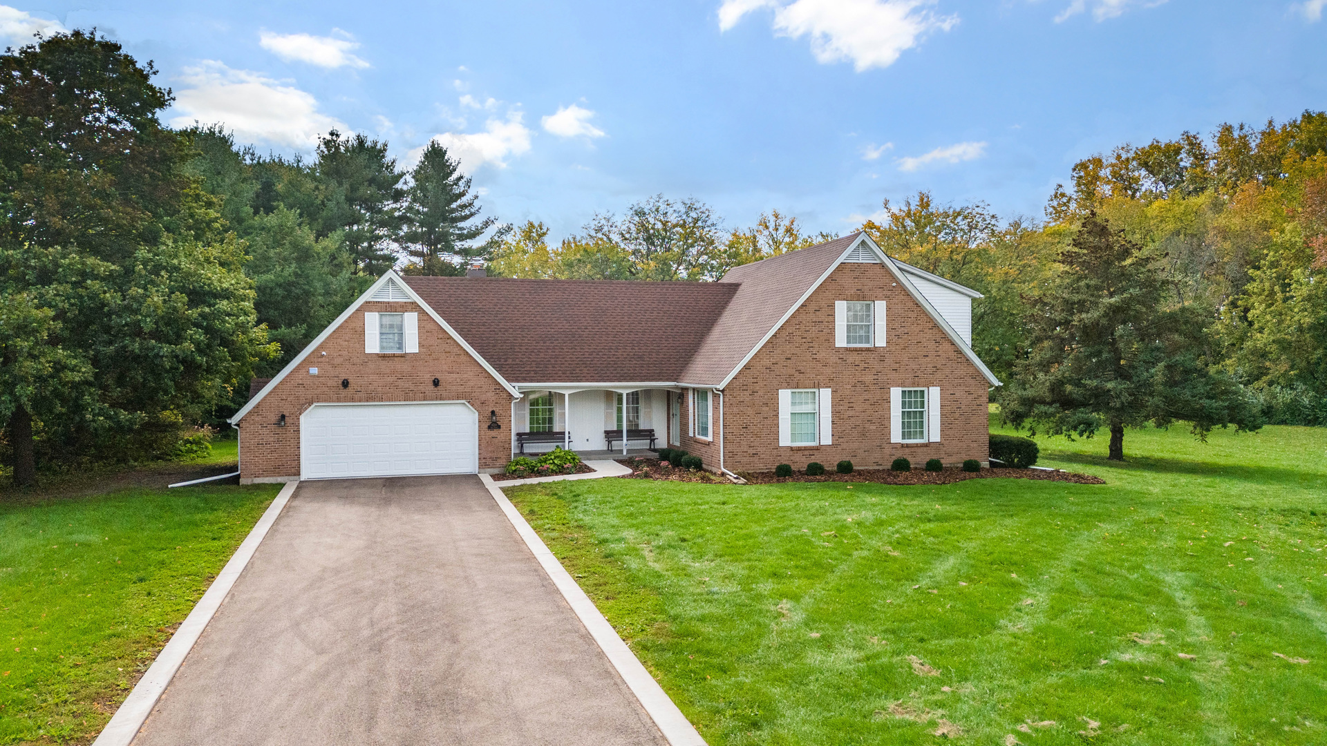 8510 Gurler Road DeKalb, IL 60115 - Photo 1 of 46 a front view of a house with a yard and trees