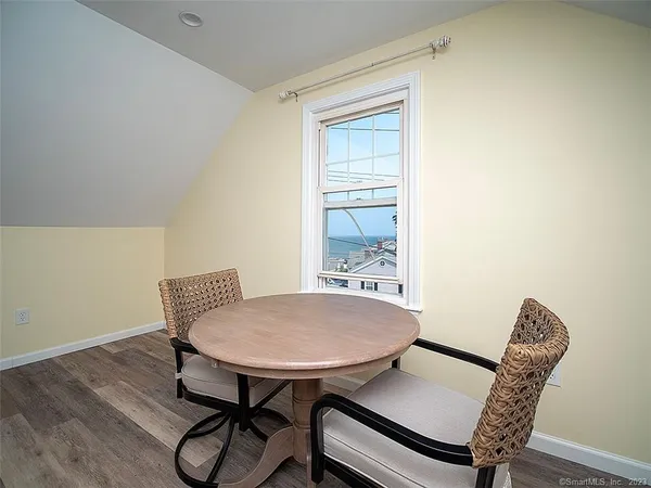 a view of a room with furniture wooden floor and a window
