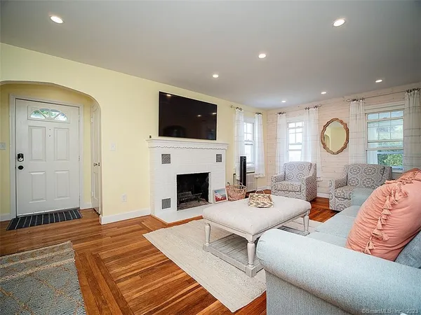 a living room with furniture a fireplace and a flat screen tv