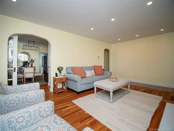a living room with furniture and wooden floor