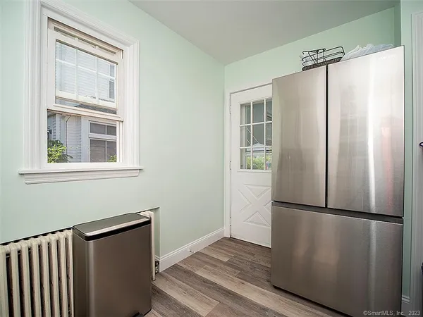 a view of a refrigerator in kitchen and wooden floor