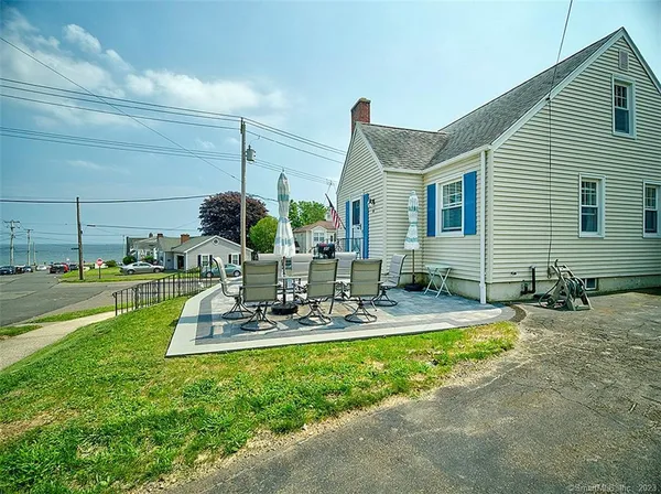 a view of a house with backyard porch and sitting area