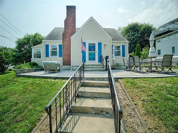 a view of house with a yard and plants
