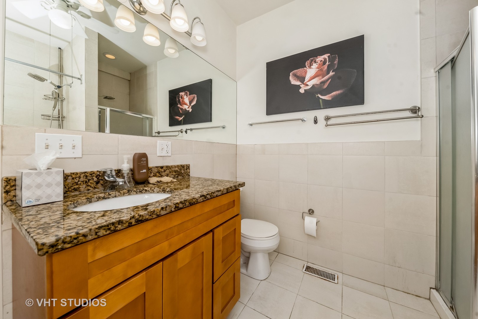 4453 South Berkeley Avenue, Unit 1 Chicago, IL 60653 - Photo 14 of 15 a bathroom with a granite countertop sink a mirror and a toilet