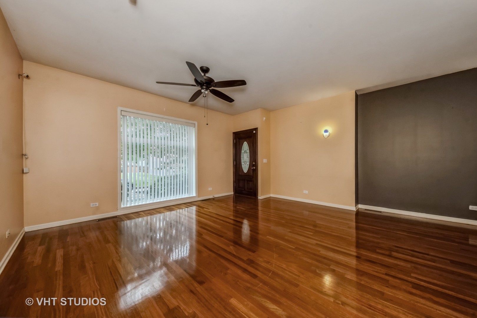 4453 South Berkeley Avenue, Unit 1 Chicago, IL 60653 - Photo 3 of 15 a view of an empty room with wooden floor and a window