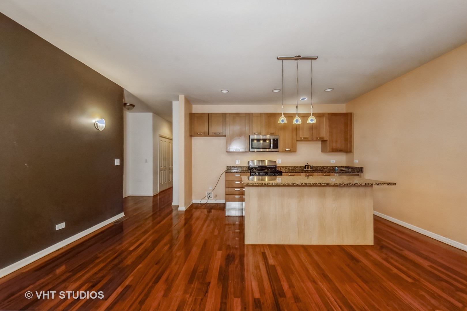 4453 South Berkeley Avenue, Unit 1 Chicago, IL 60653 - Photo 4 of 15 a kitchen with stainless steel appliances granite countertop a sink stove and refrigerator