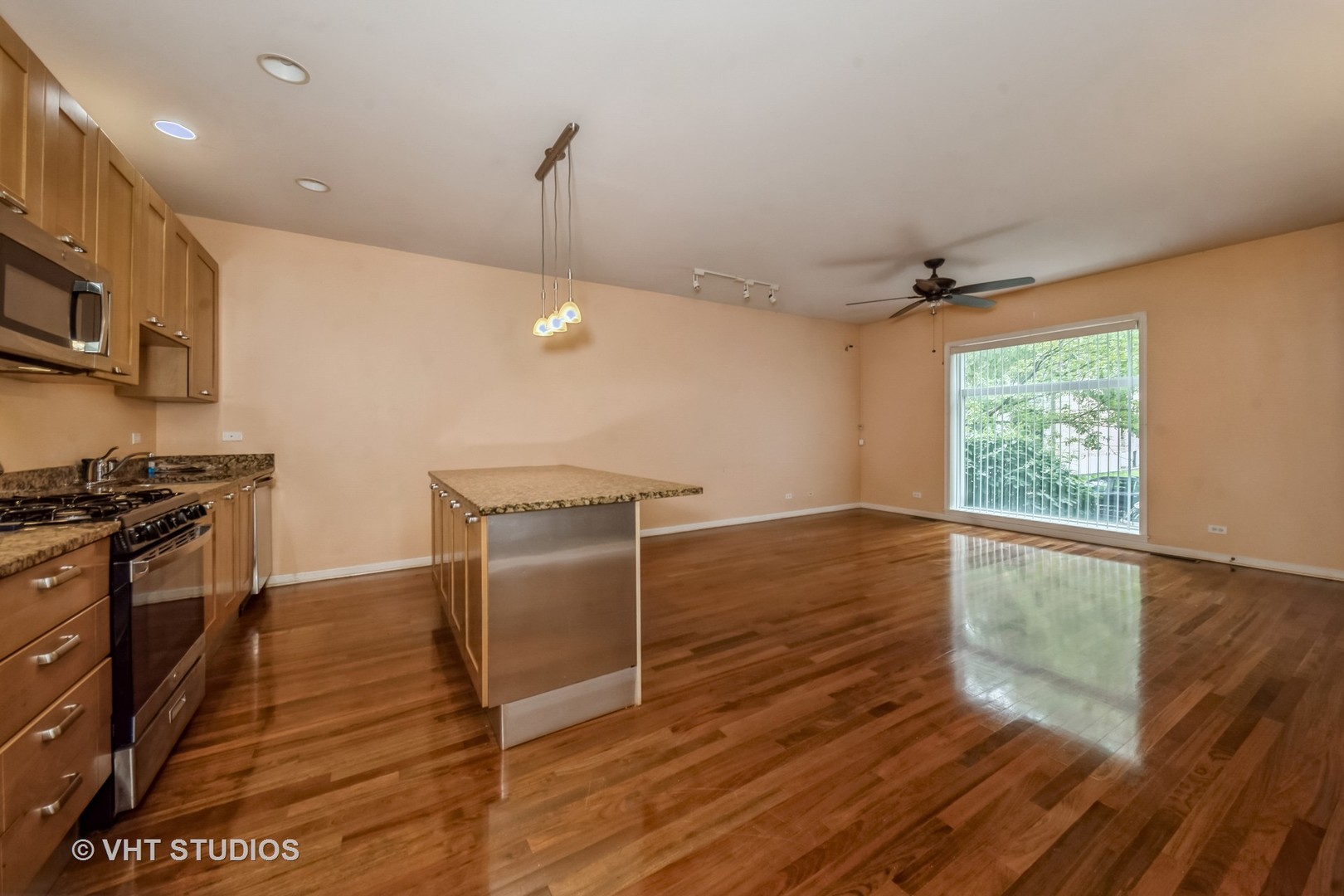 4453 South Berkeley Avenue, Unit 1 Chicago, IL 60653 - Photo 5 of 15 a kitchen with granite countertop a stove and a refrigerator