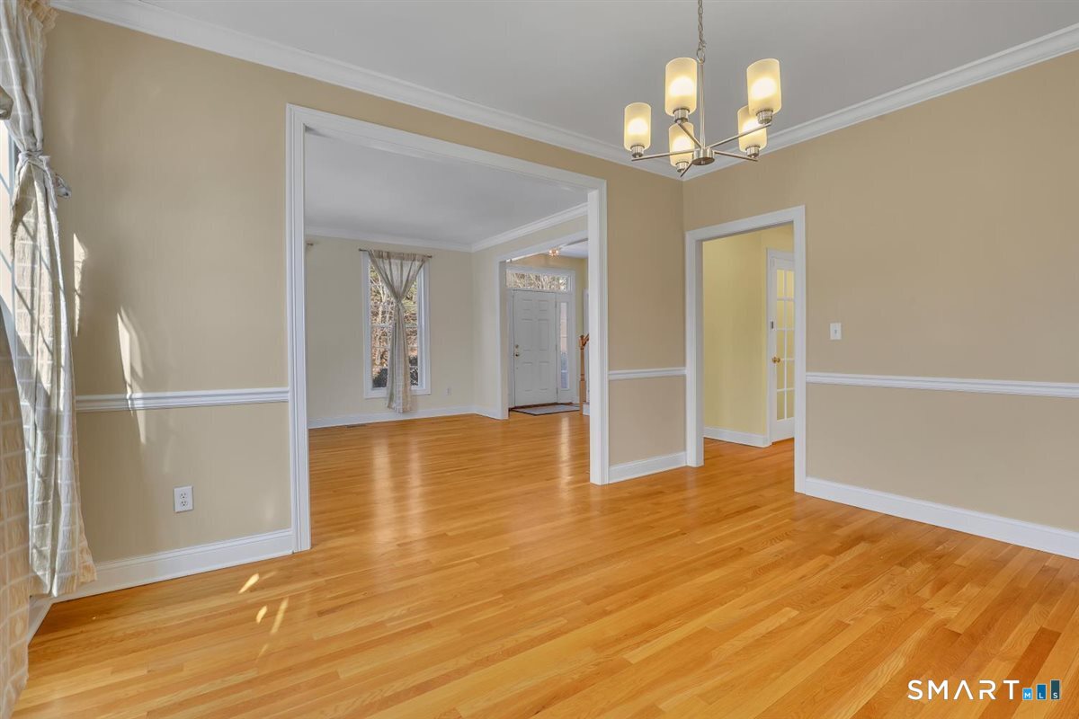 25 Fenwick Drive Avon, CT 06001 - Photo 14 of 40 a view of an empty room with window and wooden floor