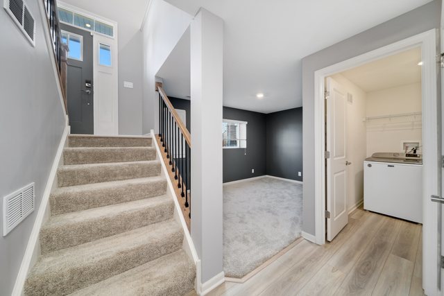 1004 Atterberg Road South Elgin, IL 60177 - Photo 17 of 22 a view of an entryway with wooden floor and stairs