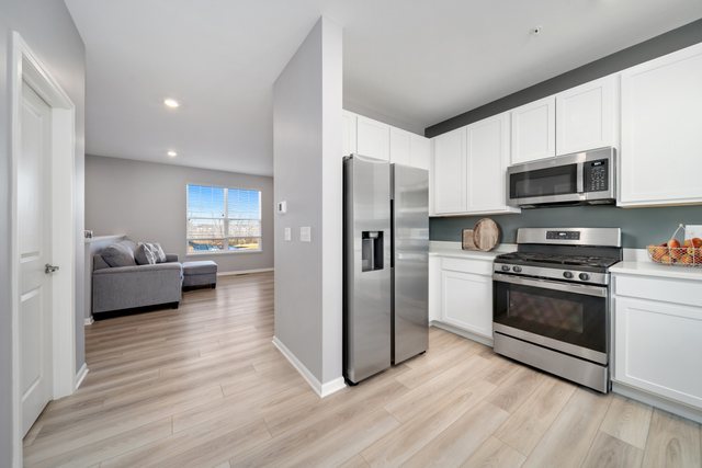 1004 Atterberg Road South Elgin, IL 60177 - Photo 5 of 22 a kitchen with stainless steel appliances a refrigerator stove and microwave