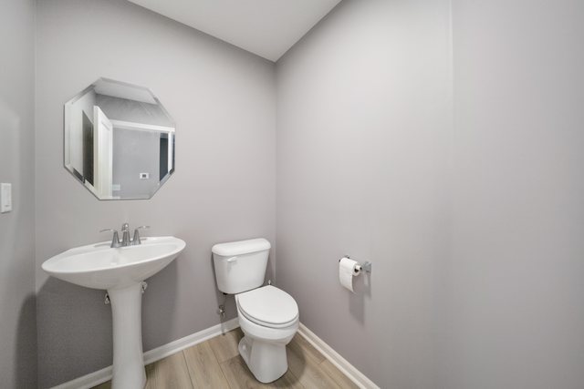1004 Atterberg Road South Elgin, IL 60177 - Photo 10 of 22 a bathroom with a toilet sink and mirror