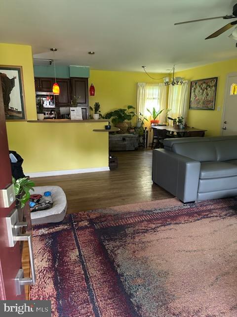 9011 Spring Acres Road Clinton, MD 20735 - Photo 6 of 11 a living room with kitchen island furniture and a wooden floor