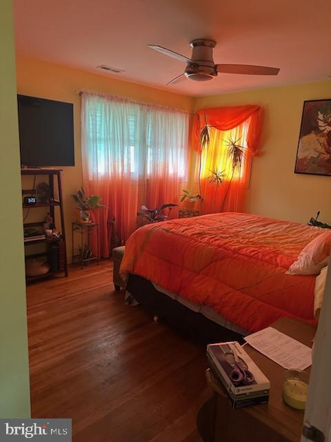 9011 Spring Acres Road Clinton, MD 20735 - Photo 9 of 11 a bedroom with a bed and a flat tv screen on dresser