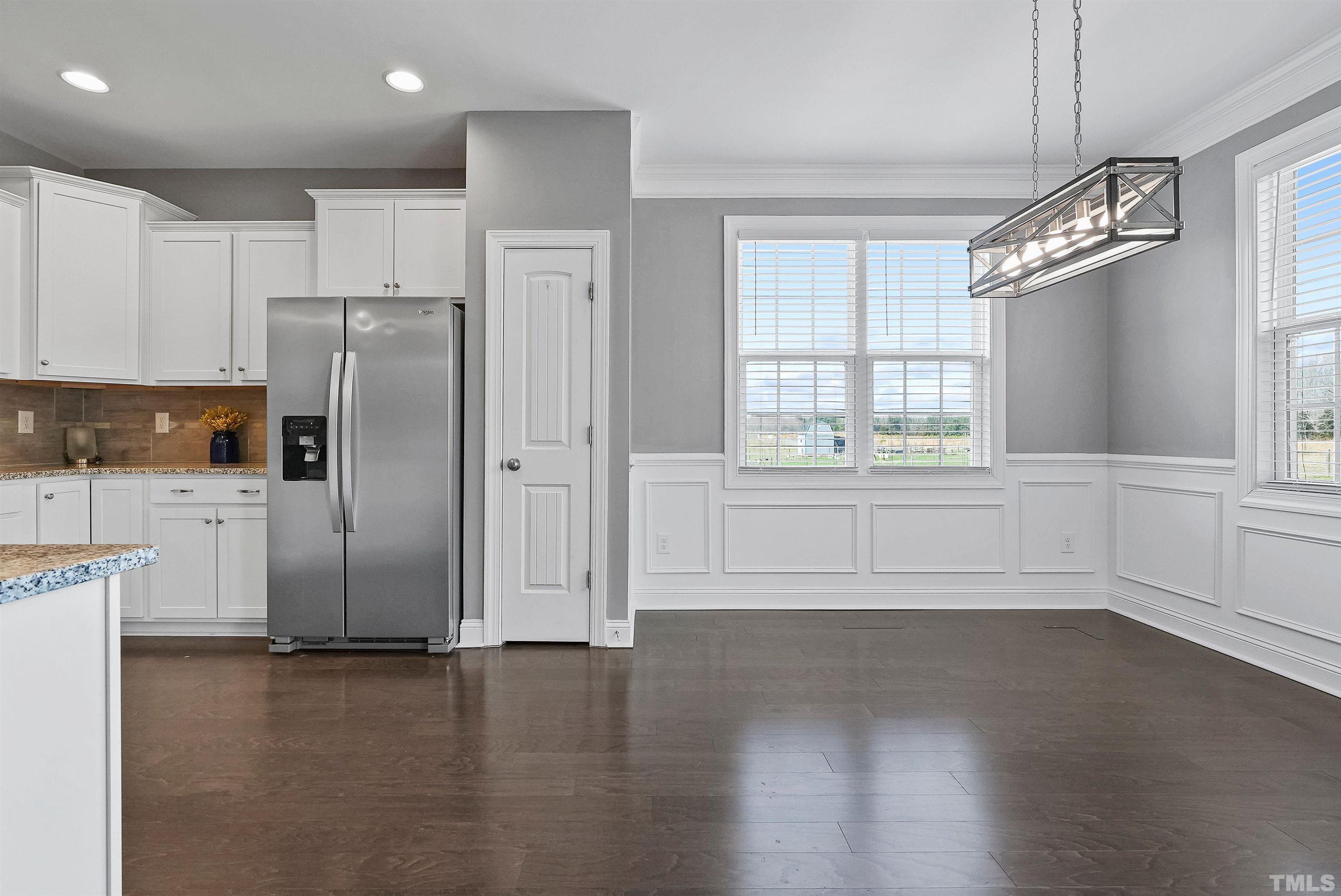 4085 Old 75 Highway Stem, NC 27581 - Photo 11 of 36 a view of a kitchen with refrigerator and wooden floor