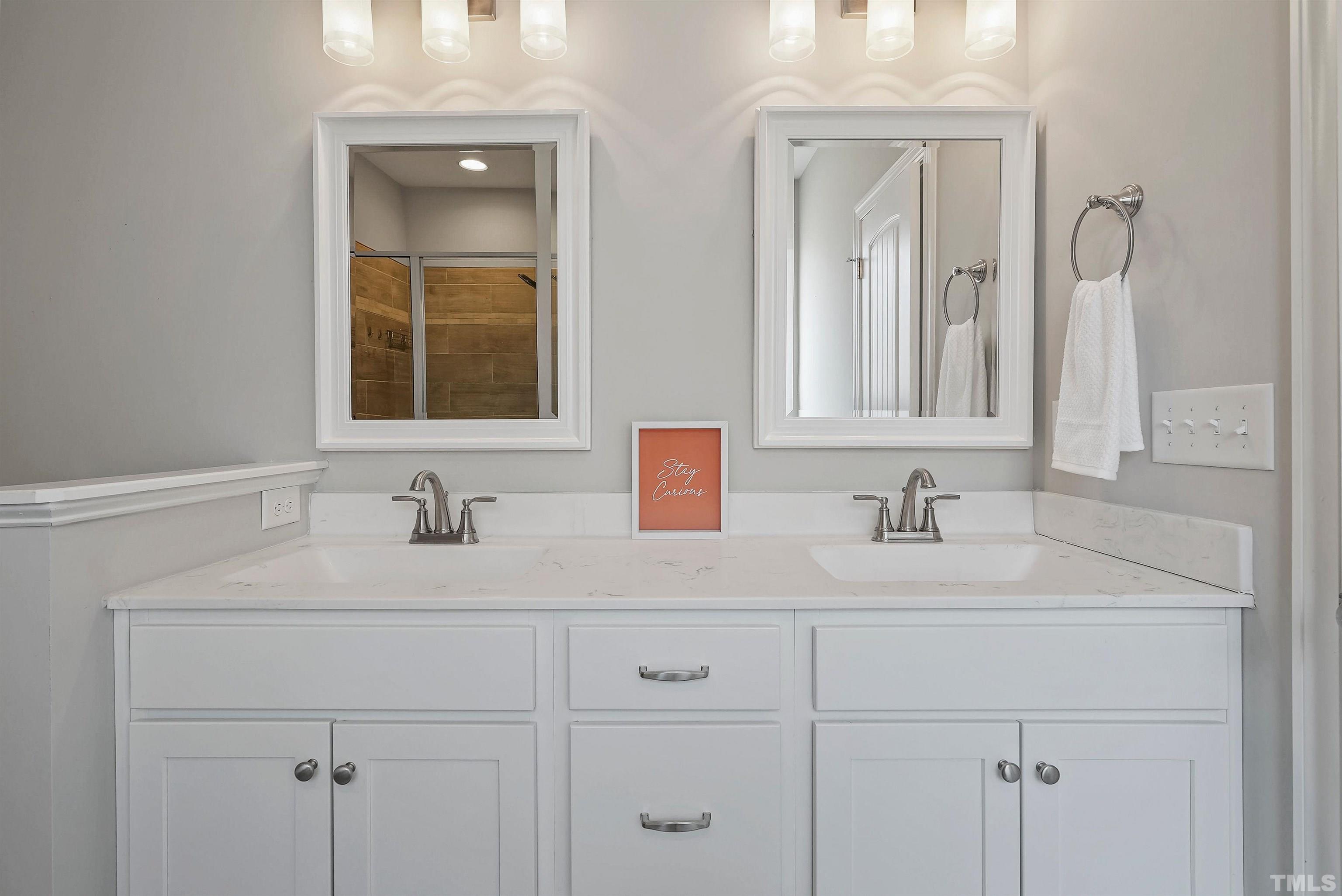 4085 Old 75 Highway Stem, NC 27581 - Photo 18 of 36 a bathroom with double sink and a mirror
