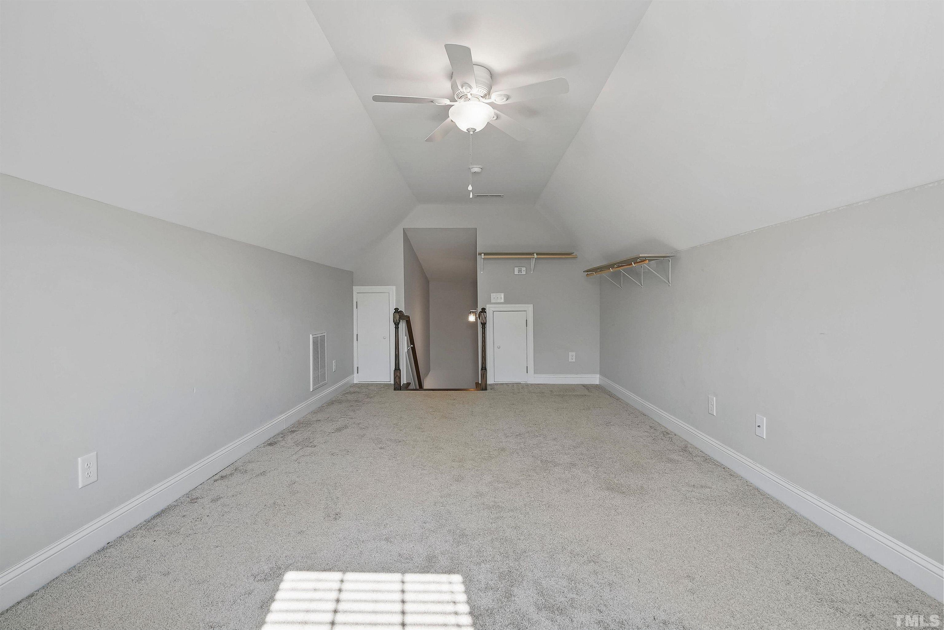 4085 Old 75 Highway Stem, NC 27581 - Photo 27 of 36 an empty room with a ceiling fan and a window