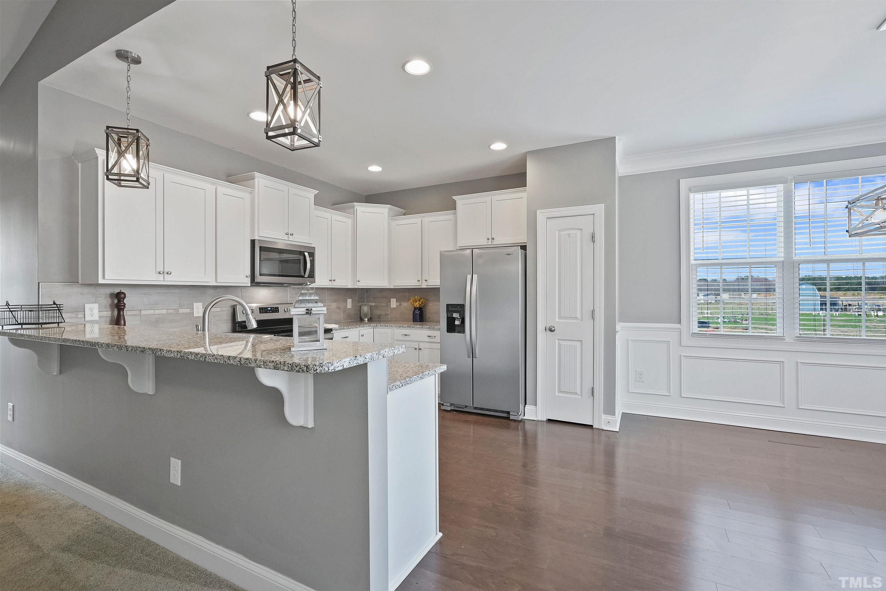 4085 Old 75 Highway Stem, NC 27581 - Photo 9 of 36 a view of kitchen with center island and stainless steel appliances