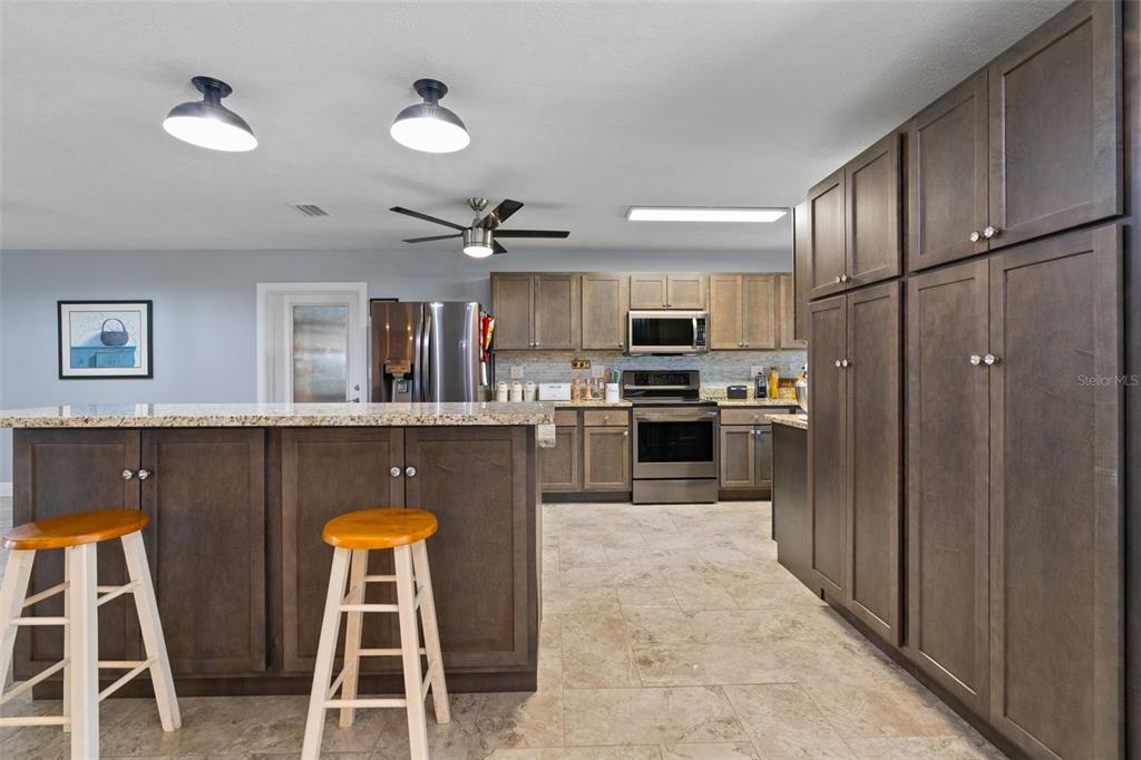 965 North Appalachian Terrace Crystal River, FL 34429 - Photo 11 of 65 a kitchen with stainless steel appliances granite countertop a refrigerator and microwave