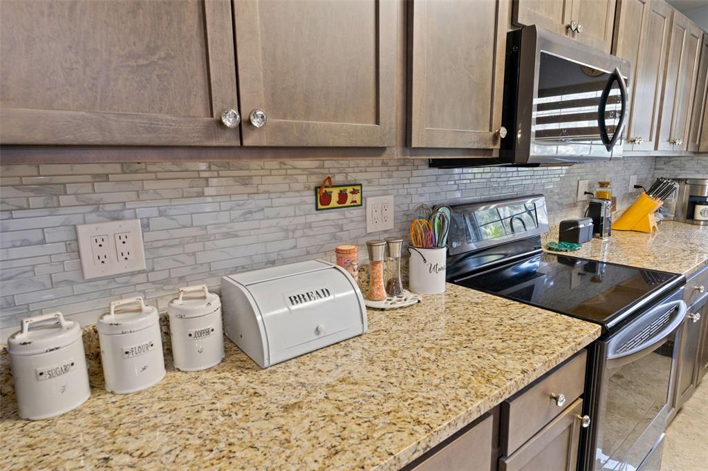 965 North Appalachian Terrace Crystal River, FL 34429 - Photo 14 of 65 a kitchen with granite countertop a sink a stove and cabinets