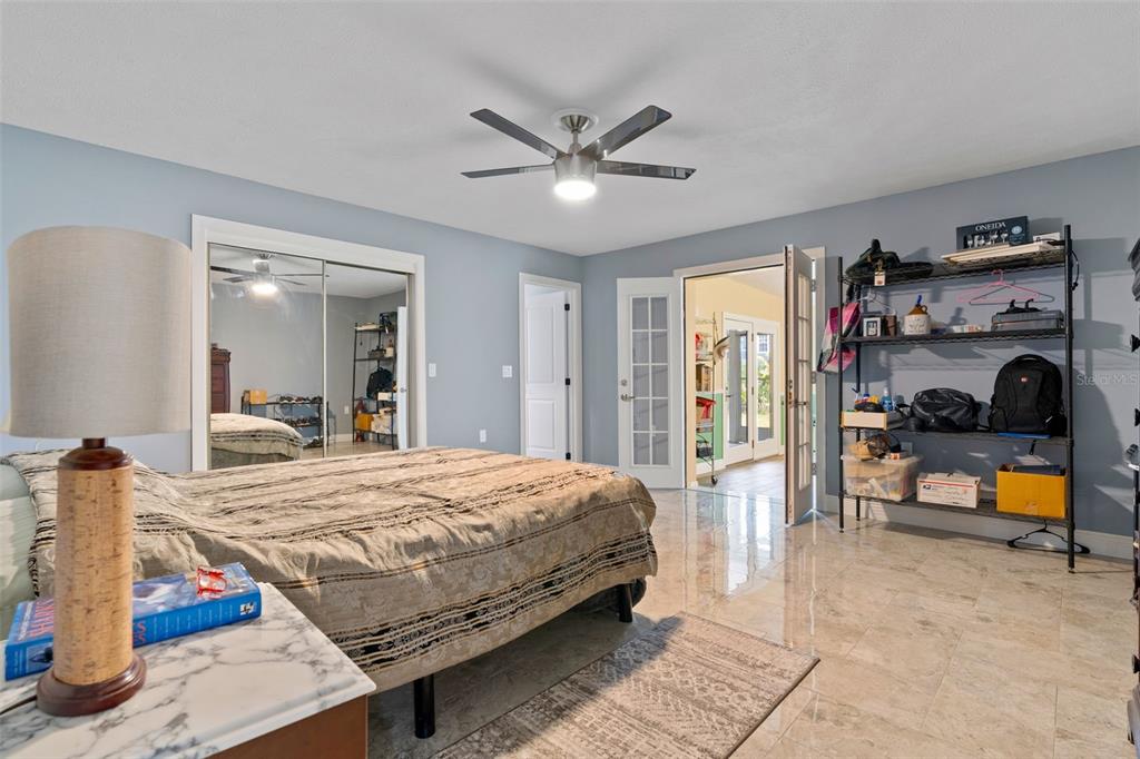 965 North Appalachian Terrace Crystal River, FL 34429 - Photo 26 of 65 a bedroom with a bed and a large mirror