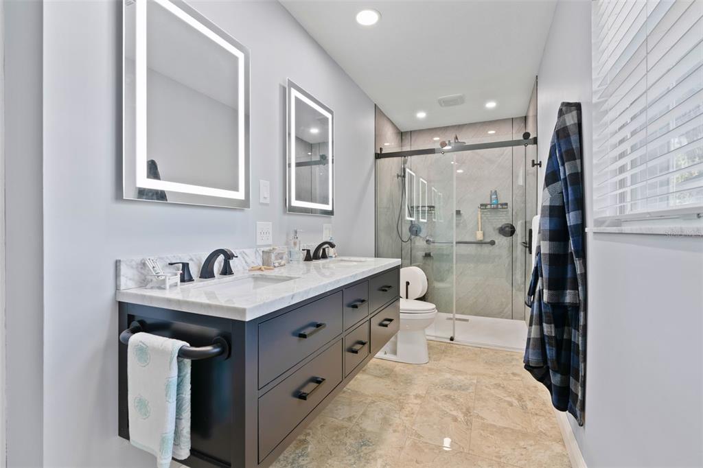 965 North Appalachian Terrace Crystal River, FL 34429 - Photo 30 of 65 a bathroom with a sink double vanity granite tub shower and a mirror